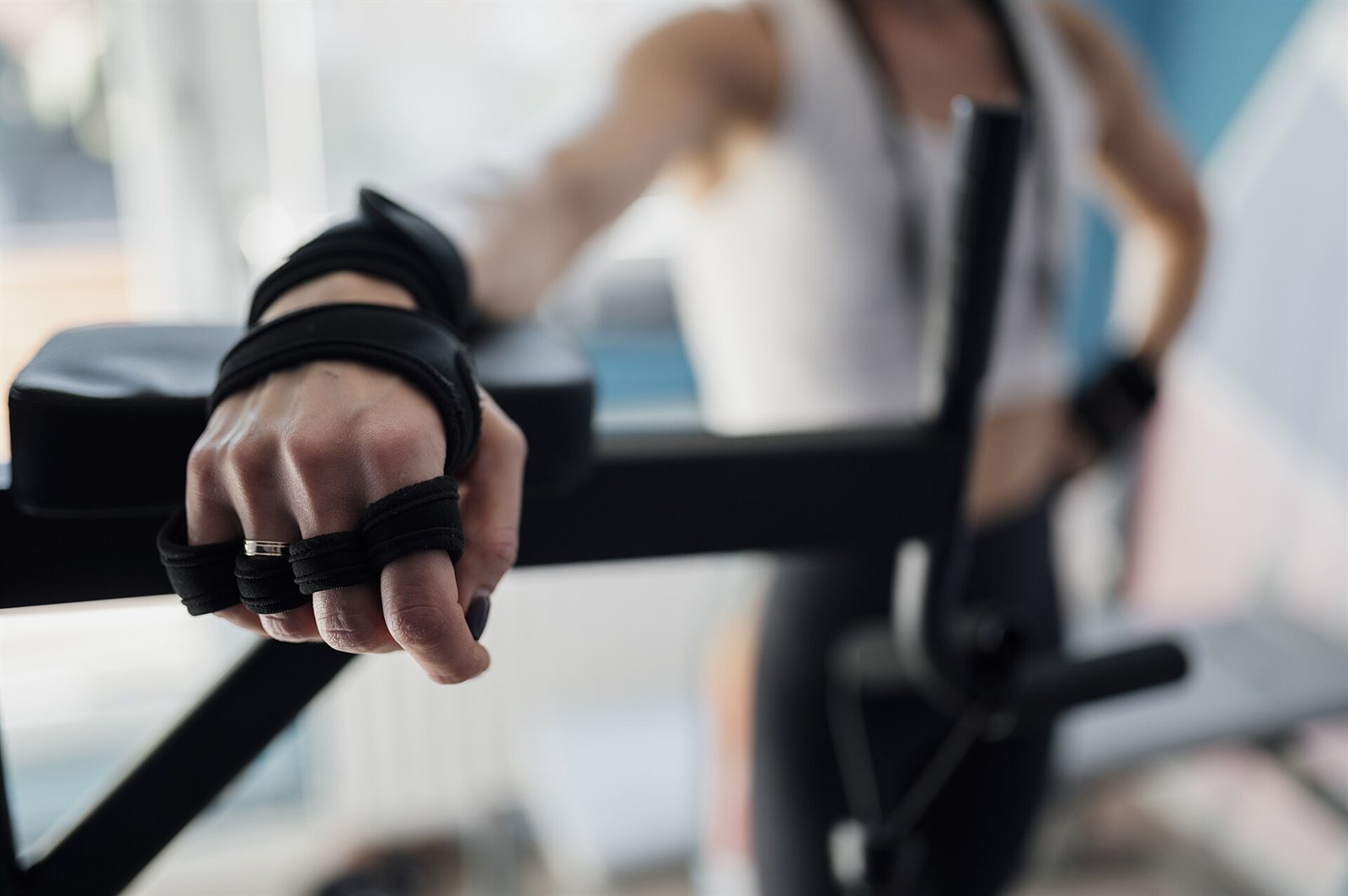 A person preparing for a strength-training workout in a gym