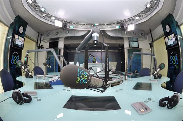 A radio studio with a broadcast desk and microphone