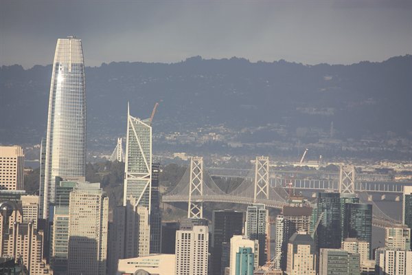 Salesforce Tower rising above the San Francisco skyline, with the Bay Bridge behind