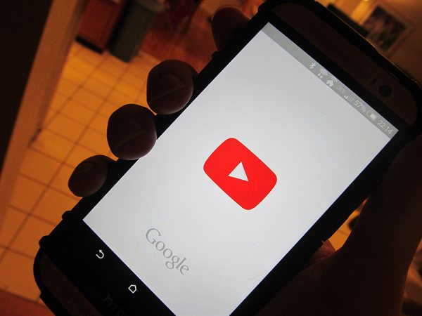 A mobile phone screen showing the YouTube app starting up